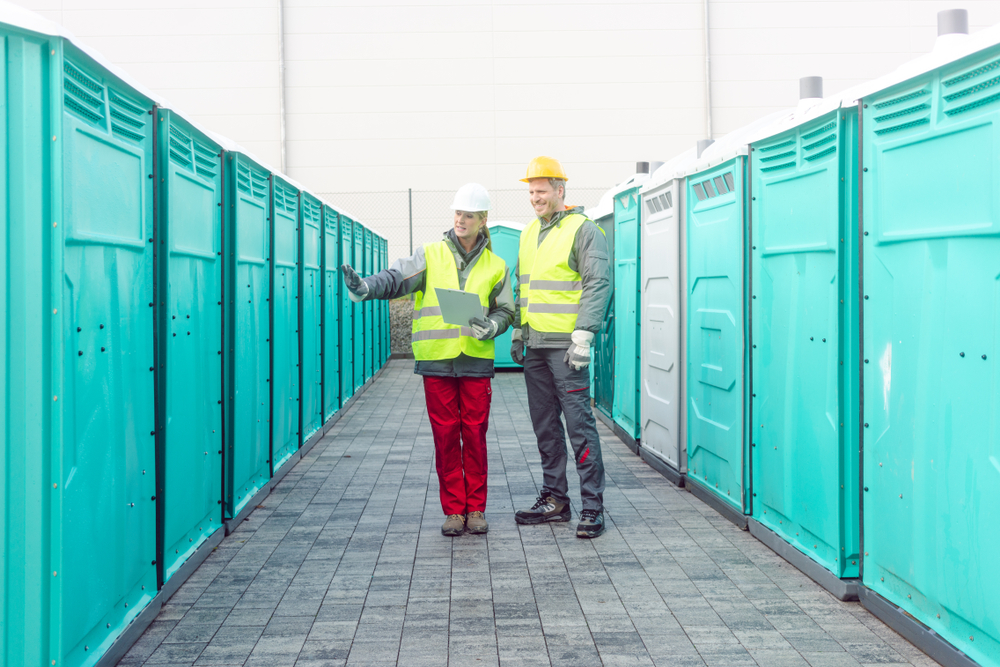 Miller Portables workers checking on portable restrooms for rent